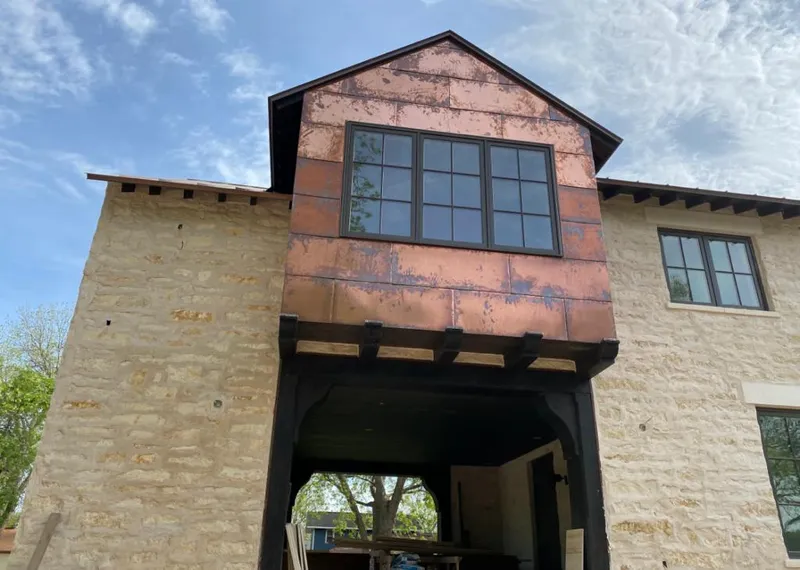 Copper metal panel facade on a stone building for Roof Repair in Ephraim